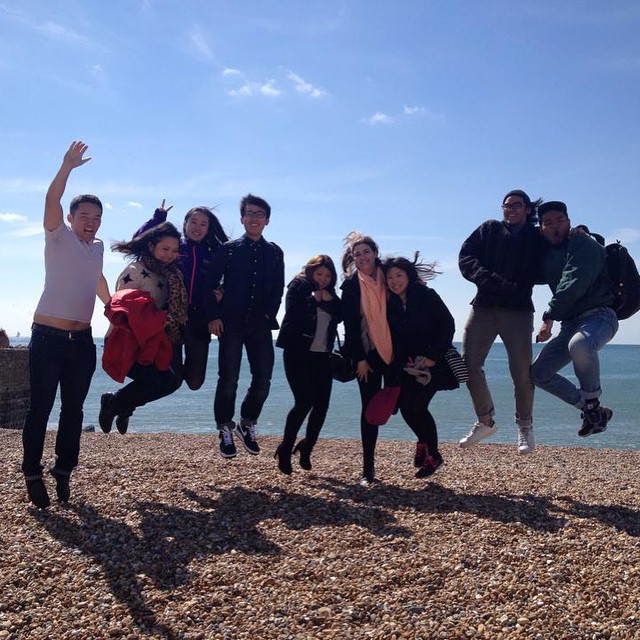 Students jumping on the beach together