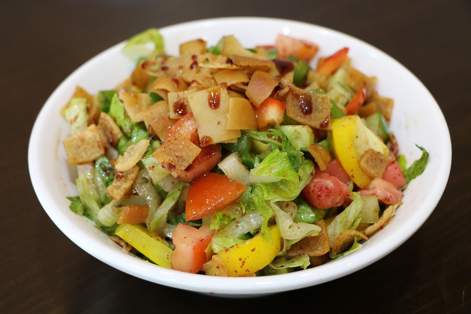 a well-presented fattoush salad in a white bowl