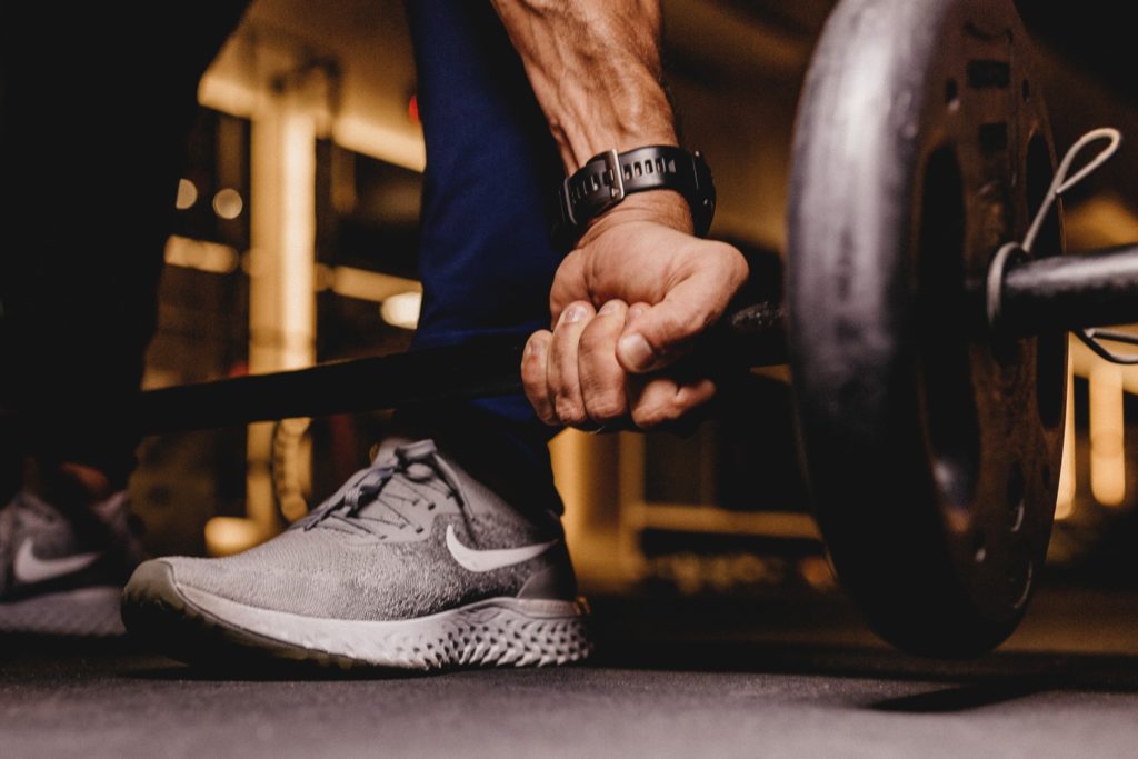 a man in a gym lifting a barbell