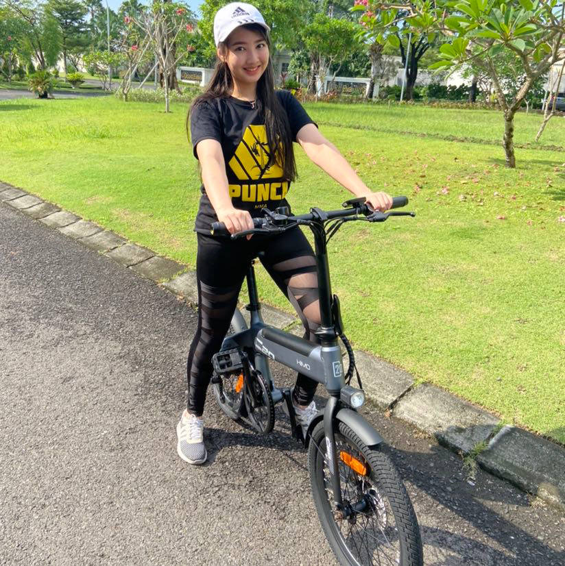 Jesselyn doing socially distant excise on a bicycle